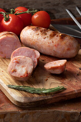 Delicious grilled sausage on cutting board.