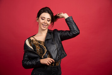 Cool girl in black leather jacket gives seductive poses