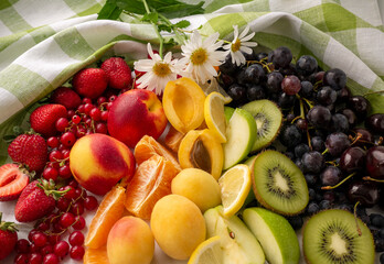 Fresh berries and fruit on a wooden background. Rainbow color. the concept of healthy eating. The view from the top