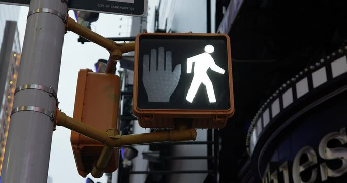 Pedestrian Traffic light in times square NYC, Manhattan. Traffic light switching from walk to don't walk. White light to red light hand. Crossing the road in safety