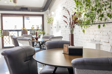 Cozy wooden interior of restaurant, copy space. Comfortable modern dining place, contemporary...