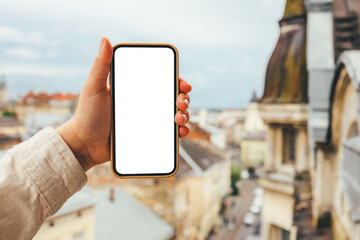 Phone with a screen in the hands on the background of the city