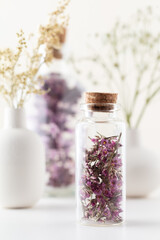 Dried herbal flowers with bottle. Homeopathy background.