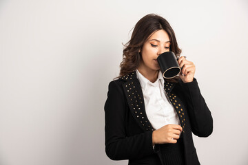 Female worker drinking tea seriously