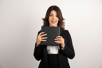 Fototapeta premium Positive teacher holding book on white background