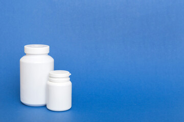 supplement pills with medicine bottle health care and medical top view. Vitamin tablets. Top view mockup bottle for pills and vitamins with green leaves, natural organic bio supplement, copy space