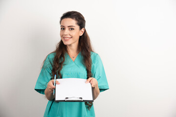 Young female medical employee holding medical records