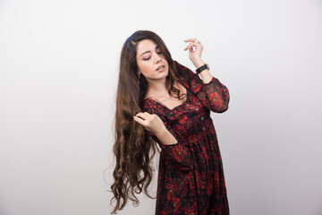 Portrait of long haired woman with closed eyes on gray background