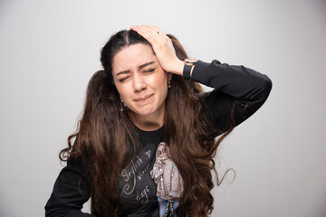 Young woman in casual sweatshirt having headache