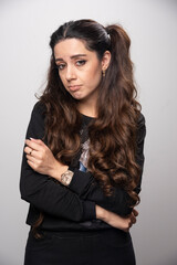 Beautiful girl with pigtailed hair standing with sad expression