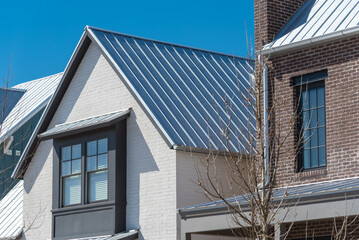 Close-up second floor of brand new house with metal roof and covered gutter near Oklahoma City, US