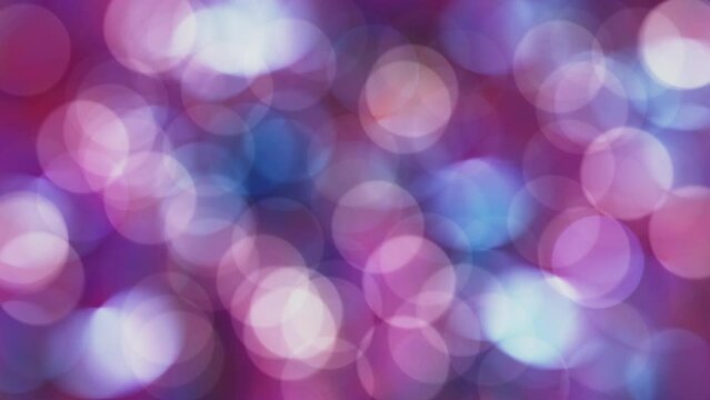 Looping 3D animation of the moving and blinking blue and pink light particles bokeh rendered in UHD as motion background