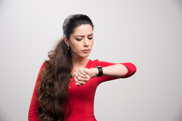 Young long haired girl looking her watch