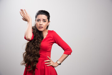 Annoyed beautiful woman one hand up.
