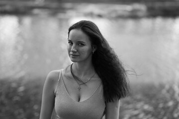 Black and white portrait of young woman near the lake