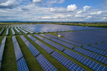 Aerial view of big sustainable electric power plant with many rows of solar photovoltaic panels for producing clean electrical energy. Renewable electricity with zero emission concept