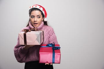 Upset young girl holding her christmas gifts