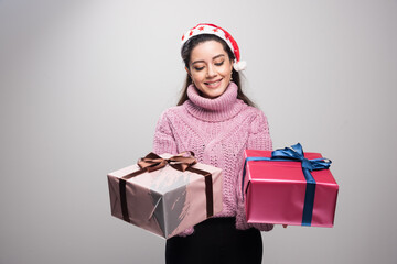 Portrait of young lady holding her christmas gifts