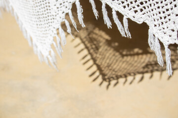 net lace shade of swing over burnt cement floor texture