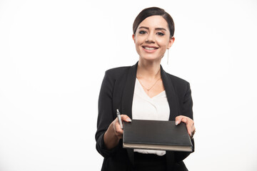 Young employee giving notebook on white background