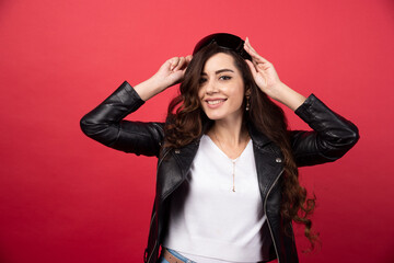 Young woman wearing black glasses on a red background