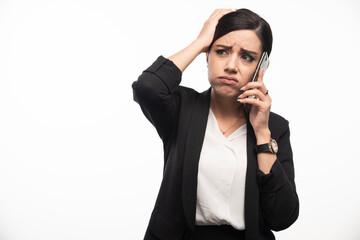 Portrait of businesswoman talking on phone on white background