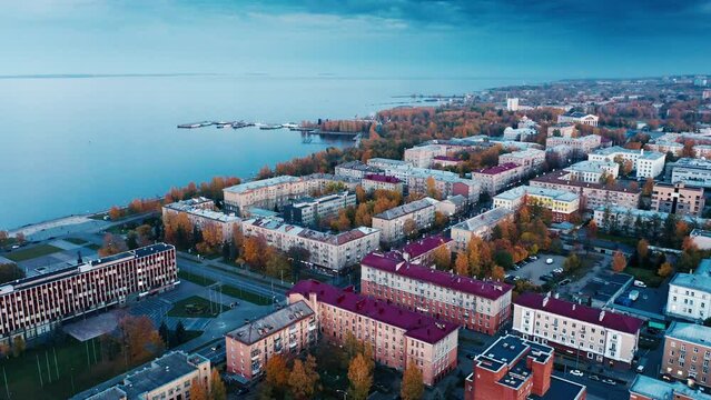 City at sunset. Aerial view of the city of Petrozavodsk and Onega lake in Russia during twilight. Drone flight over the night city