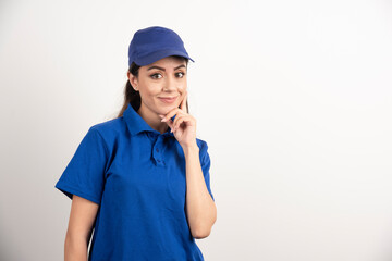 Pretty woman in blue uniform touch her face with hand