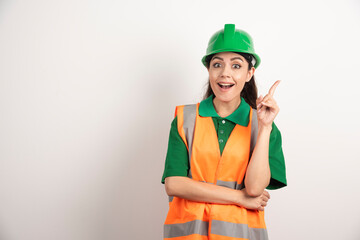 Young woman architect in uniform and helmet