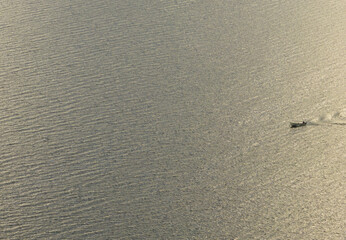 small fishing boat on the lake on a summer evening
