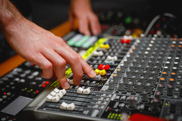 The surface with faders of a sound mixer controller.