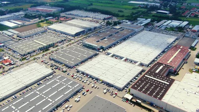 Aerial footage of a large shopping centre and car parks located in the city