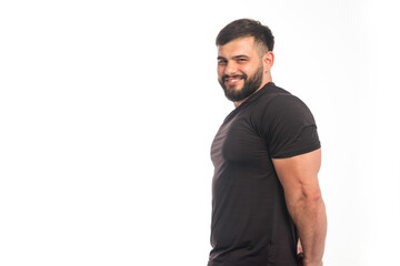 Sportive man in black shirt showing his triceps