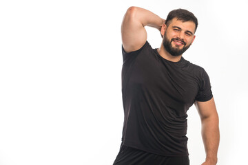 Sportive man in black shirt showing his triceps muscle