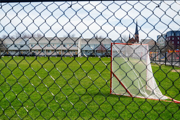 a lacrosse goal on a grass field in Porlanad, Maine.