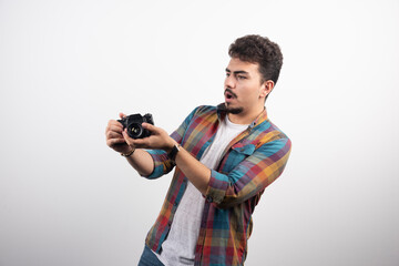 Young experienced photograph taking professional photos in a serious manner