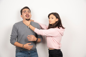 Angry woman playfully choking his boyfriend