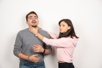 Angry woman playfully choking his boyfriend