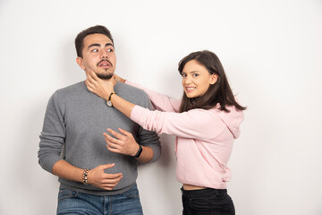 Angry woman playfully choking his boyfriend