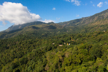 Top view of mountains covered with forest and jungle in the morning haze. Sri Lanka.