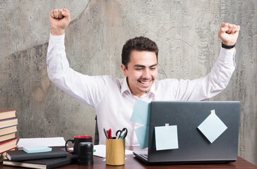 Happy businessman having best moments at the office desk