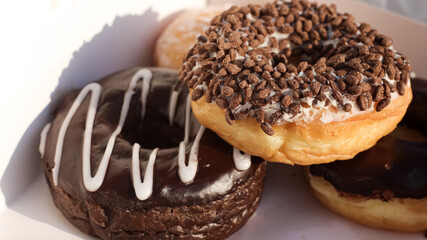 a box of donuts with flavors, fillings, and chocolate jam perfect for breakfast or a snack with coffee