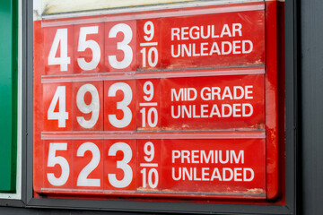 Fuel options and prices on a red sign at a gas pump at an American gas station fuel petrol oil