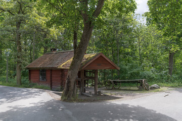 Fototapeta na wymiar An old preserved smithy house in a park a sunny summer day in Stockholm