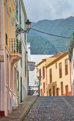 Narrow street or alley between colorful buildings in Santa Cruz, de La Palma. Bright and vibrant classical architecture in a small city or village. Beautiful houses or homes with a vintage design