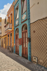 City alley view of residential houses and buildings in a quiet street in Santa Cruz, La Palma, Spain. Historical spanish and colonial architecture in a tropical village and famous tourism destination