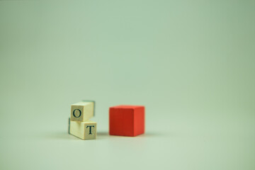 The abbreviation OT on wooden cubes. OT acronym over time. The remunerations special