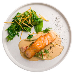 Salmon steak on the grill with spinach on white plate top view isolated on white background
