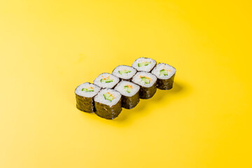 cucumber maki roll on yellow background © Алиса Королевская