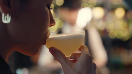 Close up of Attractive Caucasian woman relax and enjoy hangout nightlife and drinking fancy cocktail at luxury restaurant bar. Beautiful female celebrating holiday event party at nightclub in the city